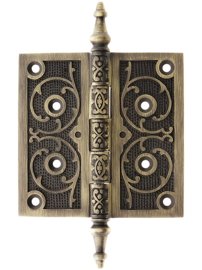 4 1/2 inch Solid Brass Steeple Tip Hinge With Decorative Vine Pattern in Antique Brass.